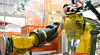 Was sich da in gefährlichem Orange-Schwarz um den Roboterarm schlängelt, ist keine Boa Constrictor, sondern die teleskopische Roboter-Energiekette Triflex TRX von Igus.