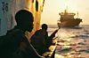 Armed Somali pirates attack container wessels at sea.